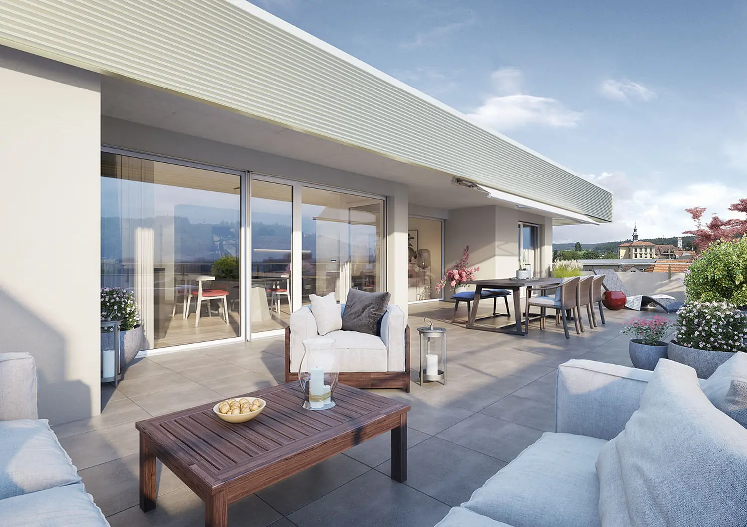 Immobilienmanagement Carmen Schwab GmbH – eine großzügige und moderne Dachterrasse, wie man sie häufig in einer Dachgeschosswohnung oder einem Penthouse findet, auf Deutsch auch „Attikawohnung“ genannt.